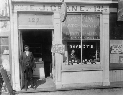 E.J. Crane, watchmaker and jewelry store, c.1899 by American Photographer